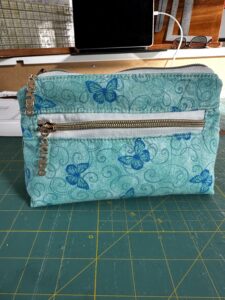 small bag with zipper closer and front zipper pocket